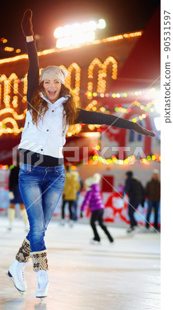 Shes queen of the rink. Shot of a beautiful young woman skating on an ice rink at night. Shes queen of the rink. Shot of a beautiful young woman skating on an ice rink at night. 90531597