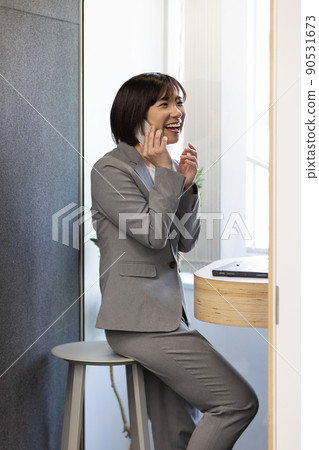 Soundproof office box Business woman speaking at a telework booth Soundproof office box Business woman speaking at a telework booth 90531673