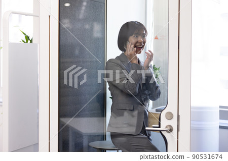 Soundproof office box Business woman speaking at a telework booth Soundproof office box Business woman speaking at a telework booth 90531674