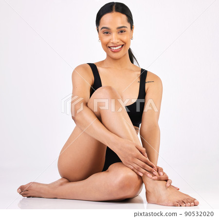 Happy skin, happy me. Full length portrait of an attractive young woman posing in studio against a grey background. 90532020