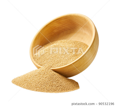 Grains amaranth are scattered out of the wooden bowl. 90532196