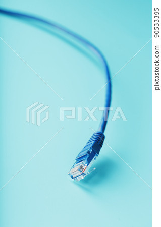 Blue Ethernet Cable Cord Patch cord on a blue background with free space Blue Ethernet Cable Cord Patch cord on a blue background with free space 90533395