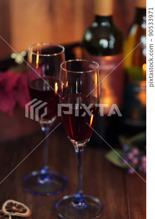 Evening drink with red wine poured into a glass in a calm atmosphere 90533971