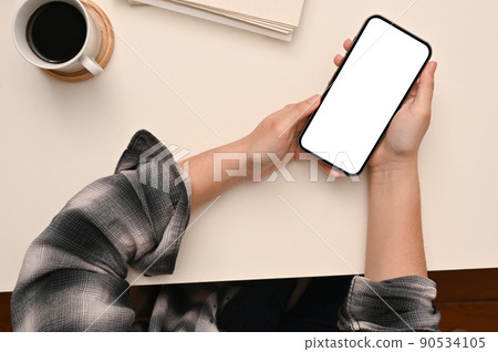 Hipster woman in Scott shirt using modern mobile phone over her modern white table. 90534105