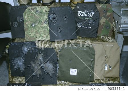 Body armor plates for army bulletproofs with bullet holes put on stand. Made by Velmet, Ukraine, tested and certified. 90535141