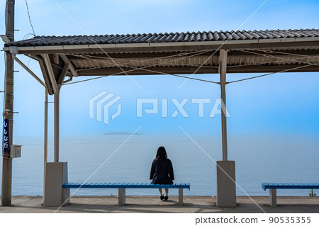 A woman looking at the spring sea at Shimonada Station, which was also the location of the drama in Futami Town, Ehime Prefecture. A woman looking at the spring sea at Shimonada Station, which was also the location of the drama in Futami Town, Ehime Prefecture. 90535355