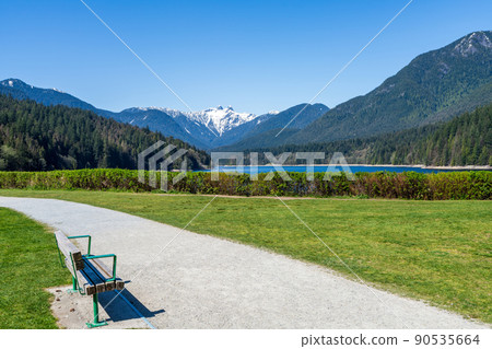 Capilano Lake Cleveland Park in springtime sunny day. Panoramic view. North Vancouver, BC, Canada. Capilano Lake Cleveland Park in springtime sunny day. Panoramic view. North Vancouver, BC, Canada. 90535664