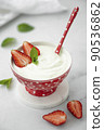fresh homemade greek yogurt with strawberries in a red bowl 90536862