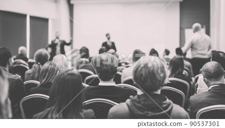 I have a question. Group of business people sitting in conference hall. Businessman raising his arm. Conference and Presentation. Business and Entrepreneurship 90537301