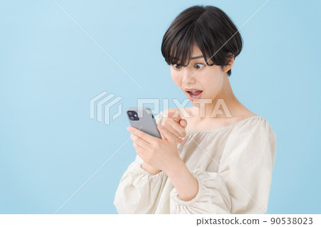 A woman with a smartphone, light blue, blue 90538023