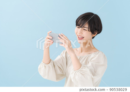A woman with a smartphone, light blue, blue 90538029