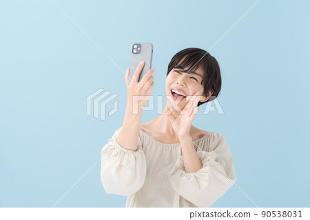 A woman with a smartphone, light blue, blue 90538031