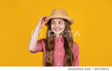 happy teen girl in straw hat on yellow background 90538052