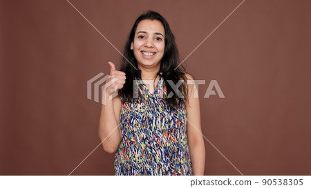 Portrait of indian woman doing thumbs up gesture on camera, giving like and approval to idea. Cool optimistic okay symbol with satisfaction and positivity, successful agreement. Portrait of indian woman doing thumbs up gesture on camera, giving like and approval to idea. Cool optimistic okay symbol with satisfaction and positivity, successful agreement. 90538305