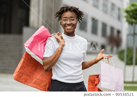 African American woman wearing casual clothes, enjoying her walk and shopping in the city African American woman wearing casual clothes, enjoying her walk and shopping in the city 90538521
