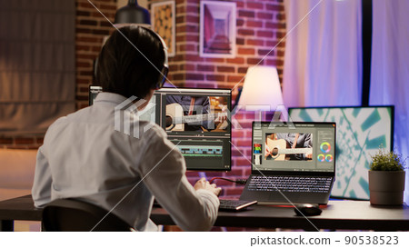 Graphic designer editing video montage on production software, working on computer to add visual effects and color gradient on footage. Edit creative multimedia film with sound. . Graphic designer editing video montage on production software, working on computer to add visual effects and color gradient on footage. Edit creative multimedia film with sound. . 90538523