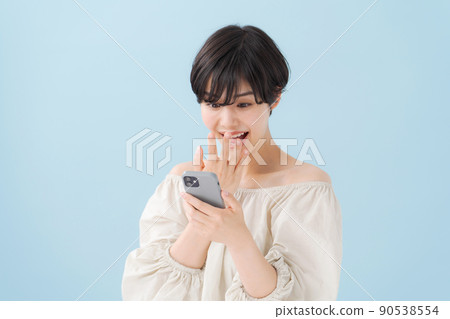 A woman with a smartphone, light blue, blue 90538554