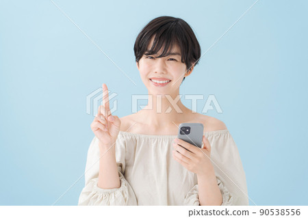 A woman with a smartphone, light blue, blue 90538556