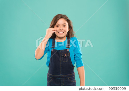Advantages of the young skin. Happy little girl touching  90539009