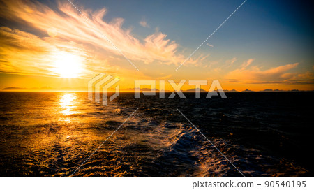 Sunset and sunrise over the sea and Lofoten archipelago from the Moskenes - Bodo ferry, Norway 90540195