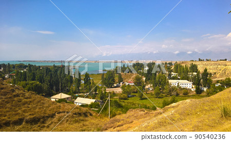 aerial panorama view to Karakol towm, formerly Przhevalsk, and Issyk-Kul lake, Kyrgyzstan 90540236