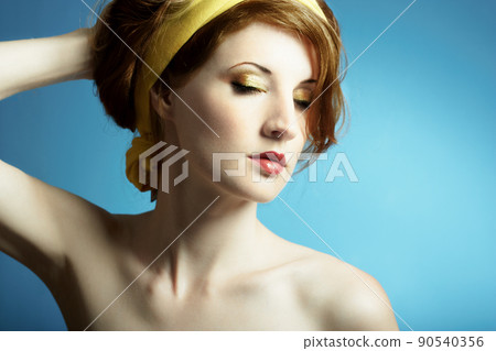Portrait of the young woman on blue background Portrait of the young woman on blue background 90540356