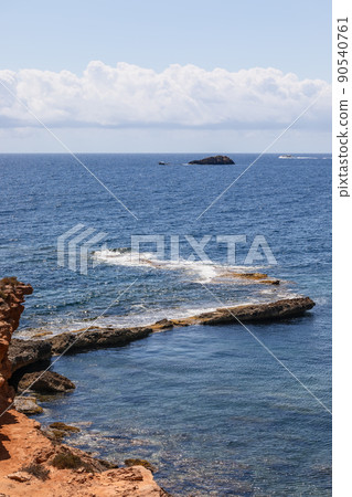 Vertical image of part of the coastal cliff smoothly disappearing underwater Vertical image of part of the coastal cliff smoothly disappearing underwater 90540761
