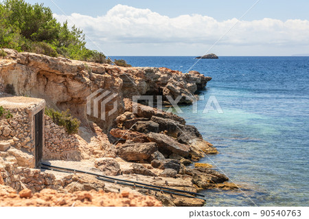 Rails lead directly from water to boat garage built in the rock 90540763