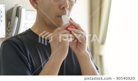 Men using asthma inhalers Men using asthma inhalers 90540920