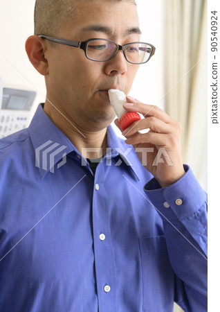 Men using asthma inhalers Men using asthma inhalers 90540924