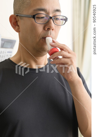 Men using asthma inhalers Men using asthma inhalers 90540925