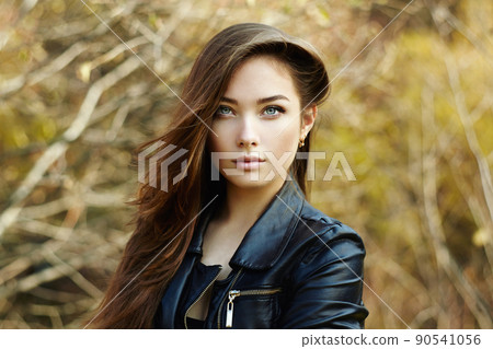 Portrait of young beautiful woman in leather jacket Portrait of young beautiful woman in leather jacket 90541056