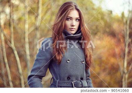 Portrait of young beautiful woman in autumn coat 90541060