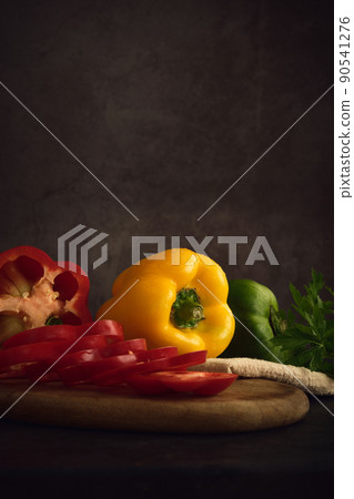 yellow green and red peppers on the cutting board yellow green and red peppers on the cutting board 90541276