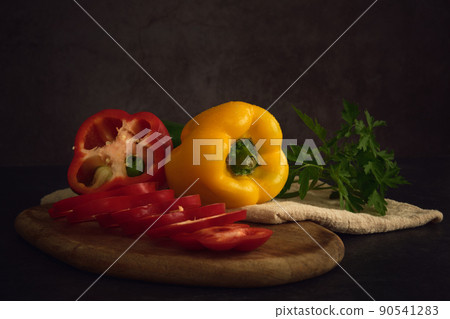 yellow green and red peppers on the cutting board yellow green and red peppers on the cutting board 90541283