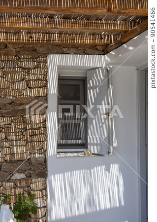 Sunlight shadow through the wooden roof of a stone villa Sunlight shadow through the wooden roof of a stone villa 90541466