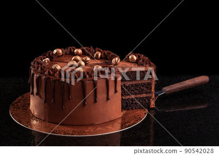 Chocolate cake with nuts on a black background Chocolate cake with nuts on a black background 90542028