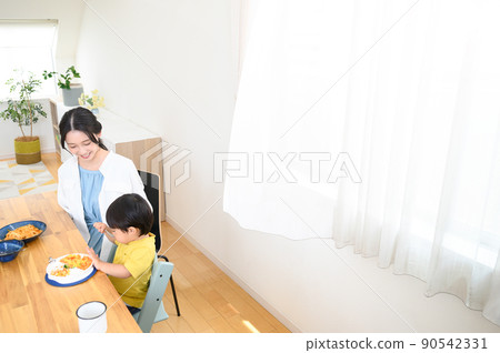 There is a copy space on the dining table with infants who often eat There is a copy space on the dining table with infants who often eat 90542331