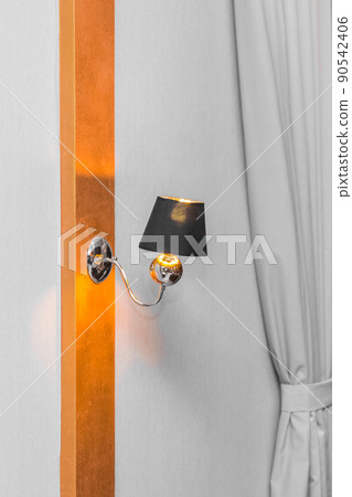 Lamp light fixture on the wall of modern interior design with light gray curtains of room decoration Lamp light fixture on the wall of modern interior design with light gray curtains of room decoration 90542406