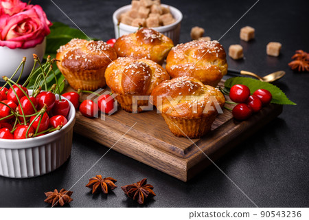 Fresh delicious rice flour muffins with cherries on a concrete background. Homemade pastries 90543236