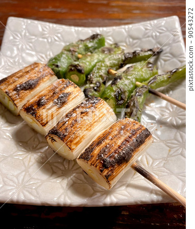 Skewers of green onions and shishito peppers Skewers of green onions and shishito peppers 90543272