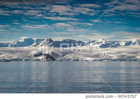 Antarctica mountains and sea. Clouds and blue sky 90543707