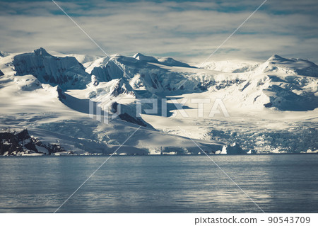 Antarctica mountains and sea. Clouds and blue sky 90543709