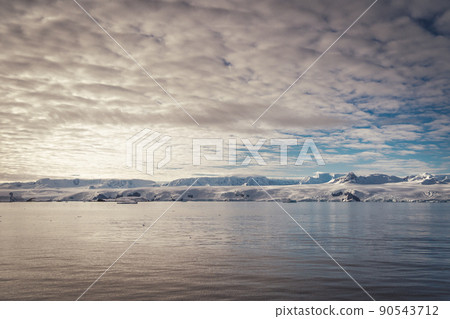 Antarctica mountains and sea. Clouds and blue sky Antarctica mountains and sea. Clouds and blue sky 90543712