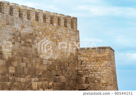 battlements of a medieval fortress against the sky, Naryn-Kala citadel in Derbent battlements of a medieval fortress against the sky, Naryn-Kala citadel in Derbent 90544151