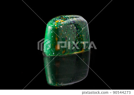 Luxury handmade chocolate candy on black background. Green candy with multicolored drops. Product concept for chocolatier 90544273
