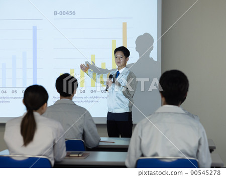 Men and women in work clothes taking seminars Men and women in work clothes taking seminars 90545278