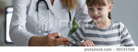Pediatrician female try to distract child attention and make diagnostic Pediatrician female try to distract child attention and make diagnostic 90545566