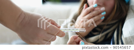 Woman coughing with high temperature symptoms of coronavirus disease Woman coughing with high temperature symptoms of coronavirus disease 90545657