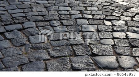 Shiny black stone pavement. Photo background 90545953